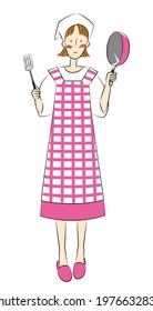 Woman holding a frying pan and a turner