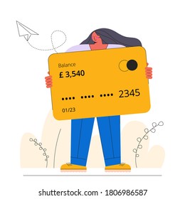 Woman holding a giant credit card in a natural environment. 