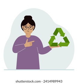 A woman is holding a green recycle, recycling or ecology sign in his hands.