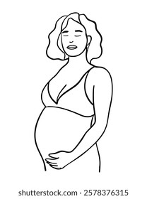 A woman is holding her stomach and looking at the camera. She is pregnant and wearing a bra