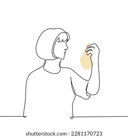 woman holding package and reading composition or checking expiration date - one line drawing vector