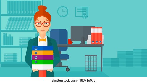 Woman holding pile of folders.