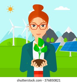 Woman holding plant.