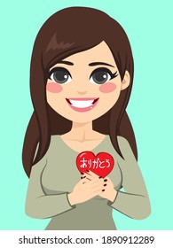 Woman holding red heart with thank you text in Japanese language