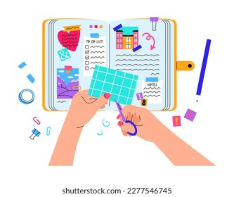 Woman holding scissors, filling diary, taking notes in notebook, decorating with stick notes, photos, envelope and scotch.