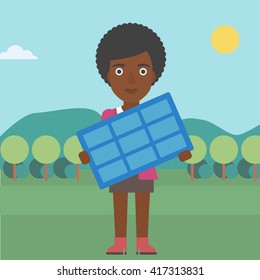 Woman holding solar panel.