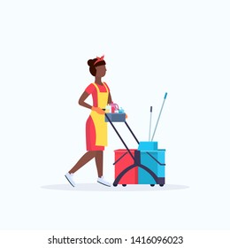 woman holding trolley cart with supplies african american female cleaner janitor in uniform cleaning service concept flat full length
