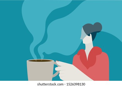 Woman holds a cup of steaming hot coffee 