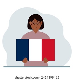 A woman holds a French flag in his hands. The concept of demonstration, national holiday or patriotism. Nationality.