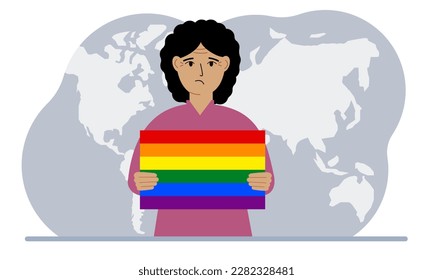 Una mujer sostiene una bandera lgbt en sus manos contra el telón de fondo de un mapa mundial.