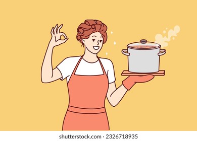 Woman housewife or cook with soup pan shows ok gesture and looks at screen smiling. Happy girl housewife in apron invites to have lunch and eat homemade food from healthy ingredients