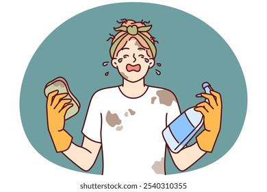 Woman housewife in dirty clothes is crying because of large amount housework and lack of rest. Girl housewife with tears in eyes holds sponge and spray bottle for cleaning in apartment