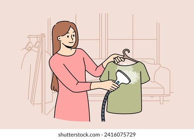 Woman housewife uses steam iron to treat clothes after washing and avoid wrinkles. Girl demonstrates work of steam iron, which simplifies housework or saves time and effort on routine activities.