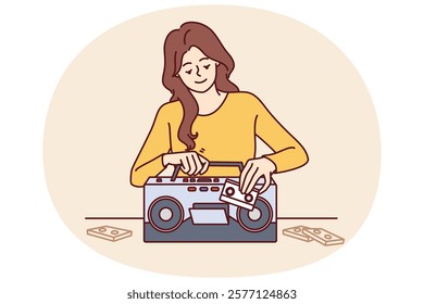 Woman inserts tape cassette into player to turn on music and start party in retro style. Happy girl with cassette recorder with smile chooses audio recording with songs from own collection