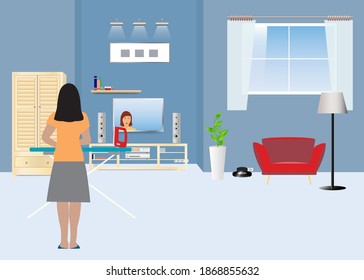 Woman is ironing with her back turned in the living room while watching TV