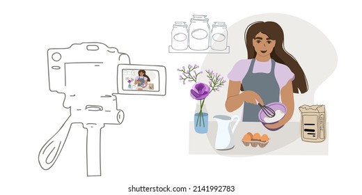 A woman in the kitchen communicates with subscribers through the camera. Food blogger preparing a cake. Online course, master class, stream, broadcast, distance learning or remote work. 