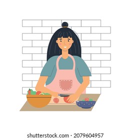 Woman in the kitchen cuts tomato into salad with knife. Cooking concept.
