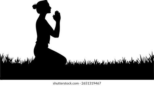 A woman is kneeling in the grass, her hands clasped in prayer, in this black and white silhouette.