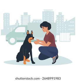 Woman kneeling and interacting with dog in urban setting with buildings and vehicle in background vector
