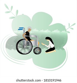 A woman kneeling with a man on a wheelchair in the garden.