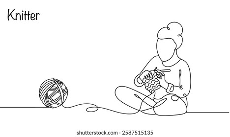 A woman knits a product from yarn with her hands. She sits comfortably on the floor, and next to her lies an unwound ball. The knitter creates unique knitted items for herself and to order.