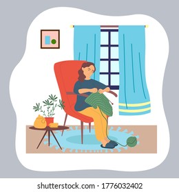 Woman knitting sitting at chair near coffee table with kettle, cup and houseplant in pot. Window with curtains and decorative carpet. Quarantine isolation at home. Hobby and leisure activities
