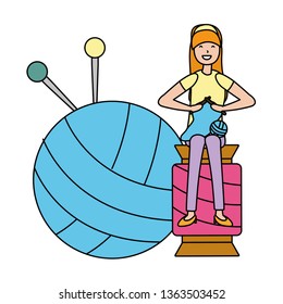 woman knitting sitting on a ball of yarn