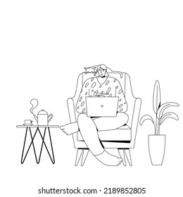 A woman with a laptop sits in a chair.