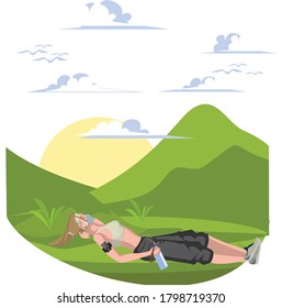 A woman laying down on the grass for resting after morning jogging