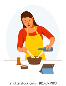 Woman is Learning to Cook Online by Herself at Home.