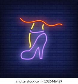 Woman leg wearing tango dance high heel shoe neon sign. Dance studio or performance design. Night bright neon sign, colorful billboard, light banner. Vector illustration in neon style.