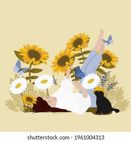 A woman lies in sunflowers and enjoys life. Black cat with a mistress.