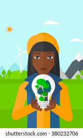 Woman with lightbulb and trees inside.