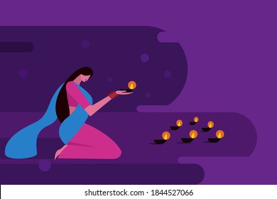 A woman lighting Diwali festival lamps in the floor