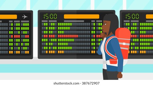 Woman looking at schedule board.