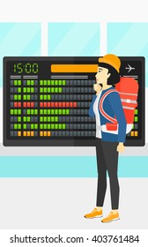 Woman looking at schedule board.