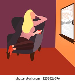 woman looking to the snowing window and drinking