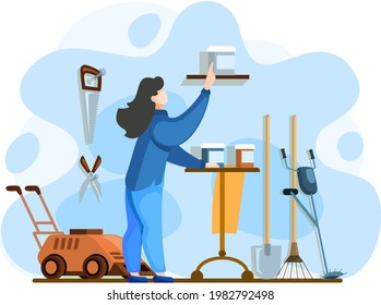 Woman looks and chooses garden tools. Young person points his finger at gray jar on shelf. Garden shop with lawn mower, rake, shovel, secateurs and saw. Gardener stands next to table with jars in barn