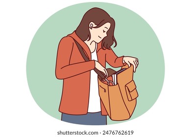 Woman looks into large bag hanging on shoulder in search of wallet or phone lost in handbag. Tourist girl with handbag dressed in casual clothes is trying to find lost or stolen personal items.