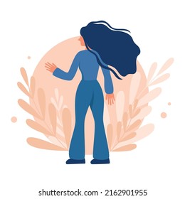 Woman with lush hair developing in the wind on a background of leaves
