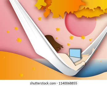  woman lying in hammock on autrumn background and working with her laptop computer. Freelance work concept.