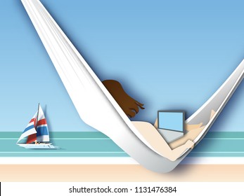  woman lying in hammock on the beach and working with her laptop computer. Freelance work concept.