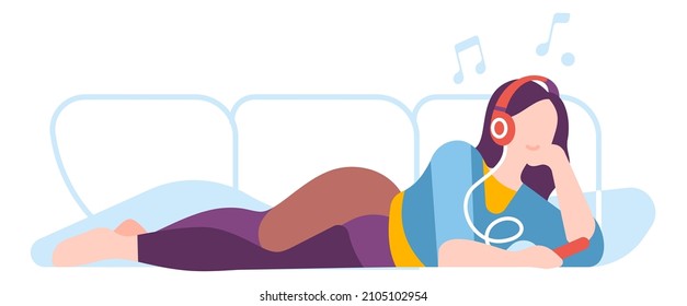 Woman lying on couch and listening music. Home relaxing concept