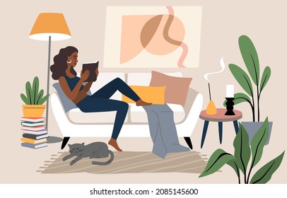 Woman lying on sofa and reading book. Female character in home interior