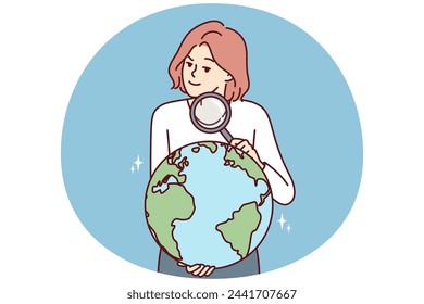 Woman with magnifying glass holds globe studying geography or choosing place for further travel. Inquisitive girl leads country search on globe for concept of international political relations