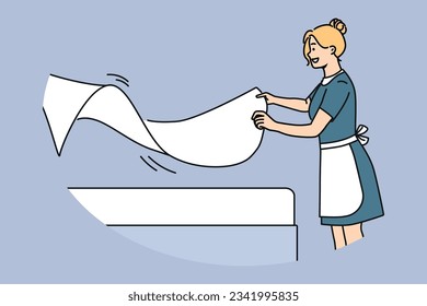 Woman maid makes bed with sheets, preparing hotel room for arrival of new guests. Maid with smile doing job enjoying career in hospitality industry and becoming professional in horeca industry