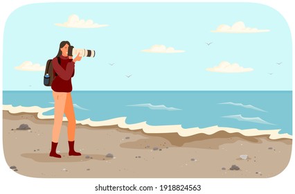 Woman is making photo of amazing landscape. Girl with camera is looking into lens. Photographer with professional camera conducts photo session of seascape. Coastline with ocean at high tide