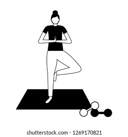 woman making yoga with mat and dumbbells
