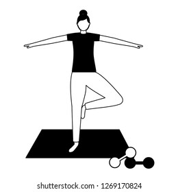 woman making yoga with mat and dumbbells