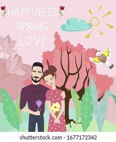 A woman and a man are happy together and stand in an embrace with flowers on the background of spring